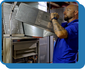 a technician replaces an air filter in a furnace system in someone's home